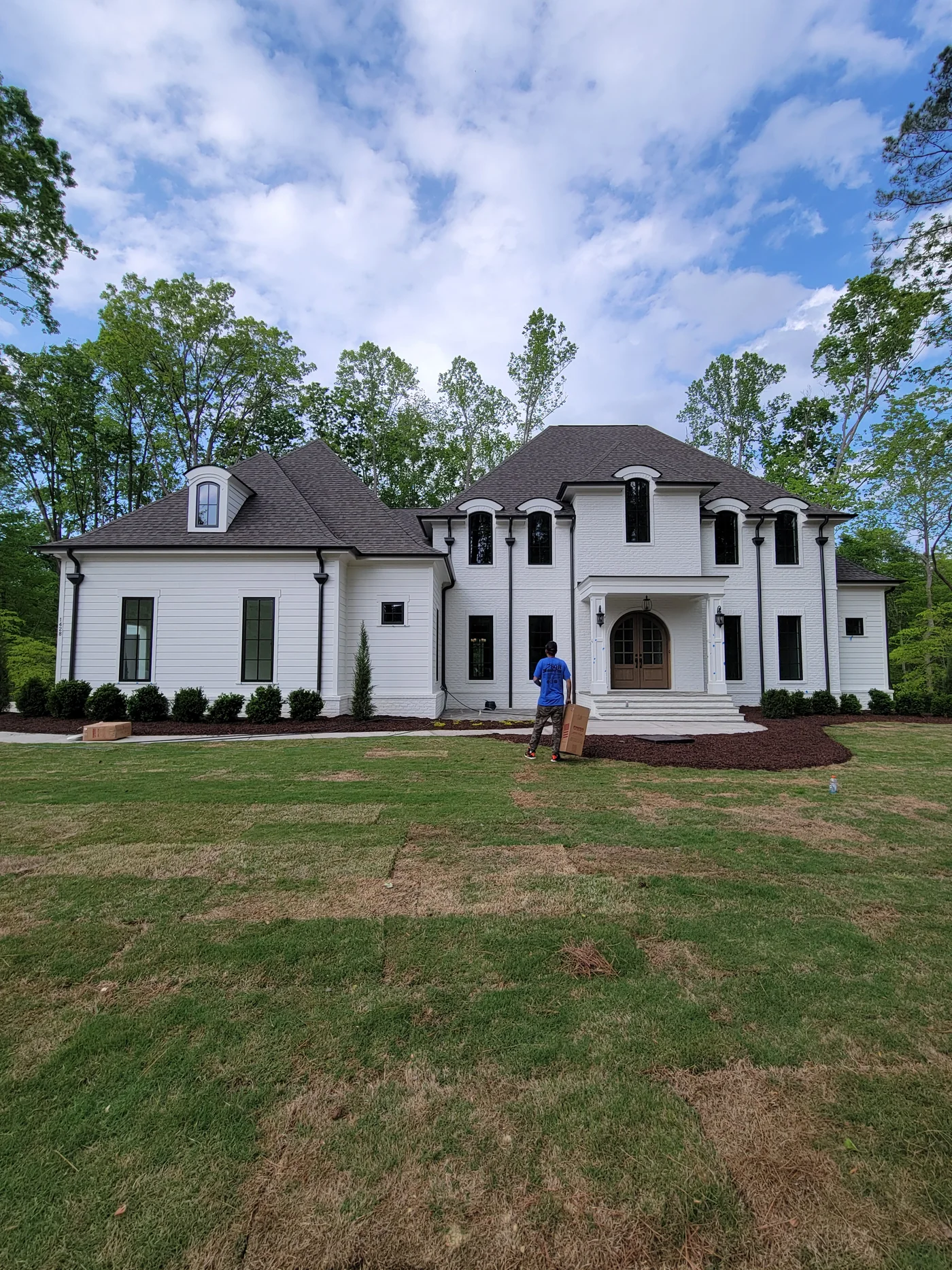 Completed gutter installation on a large white home in the SQH project gallery