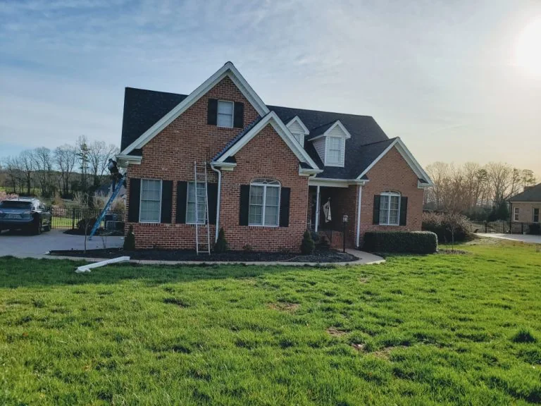 Completed dark gutters on a brick Raleigh home