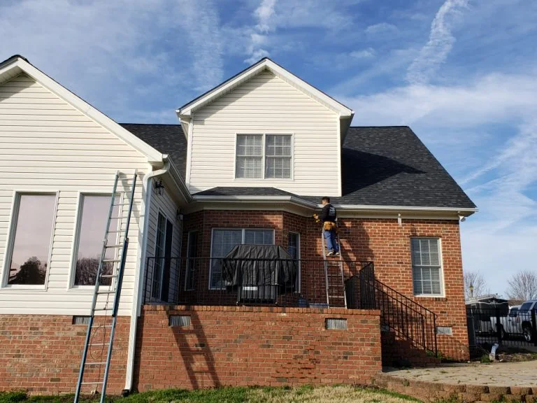 Gutter work in progress on a two-story home