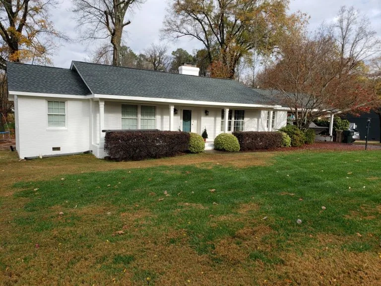 Finished gutter system on a white single-story home